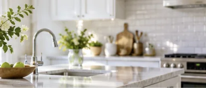 Clean white kitchen with polished counters and sink